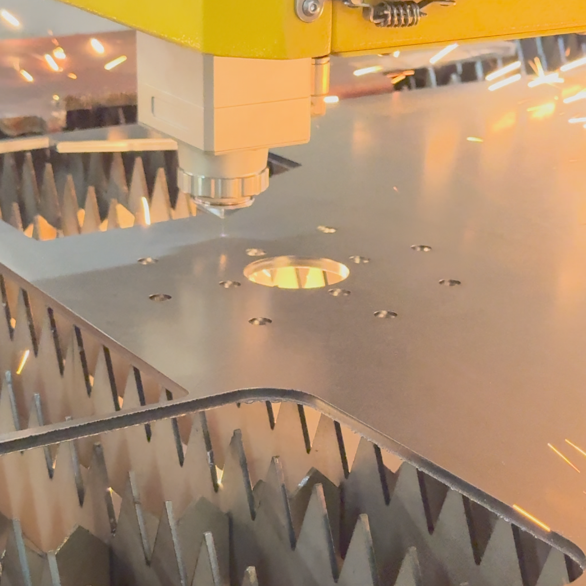 Metalworking process with a machine cutting metal, creating sparks.
