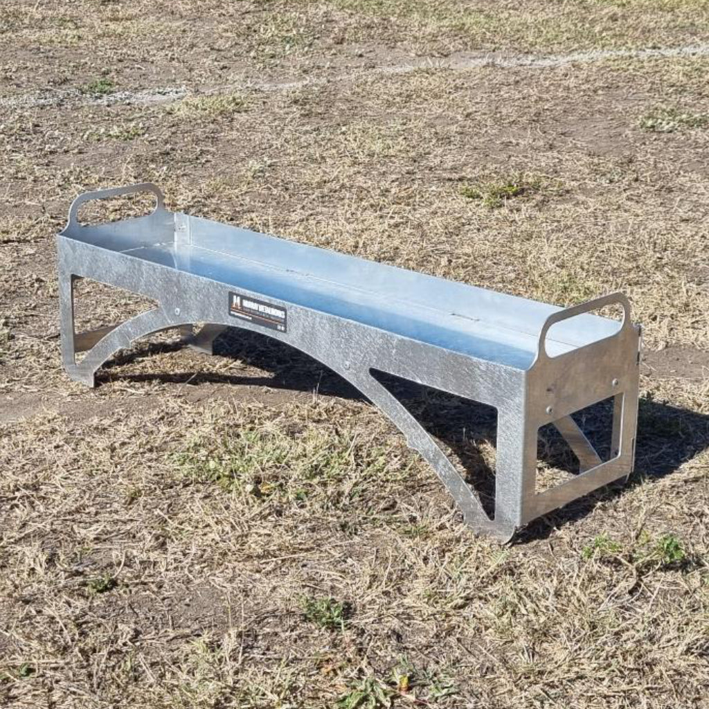 Metal tyre tool tray on a grassy field
