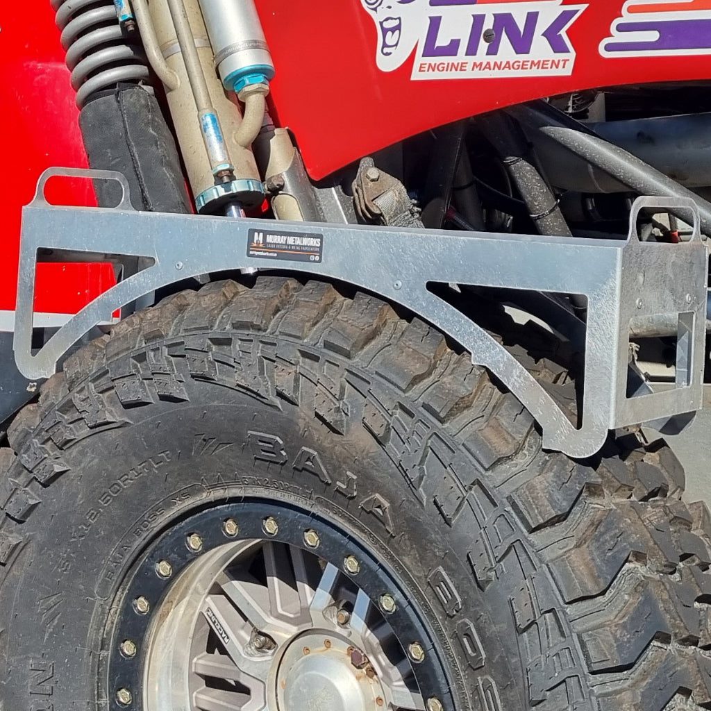 Close-up of a vehicle tire with a metal tool tray attached